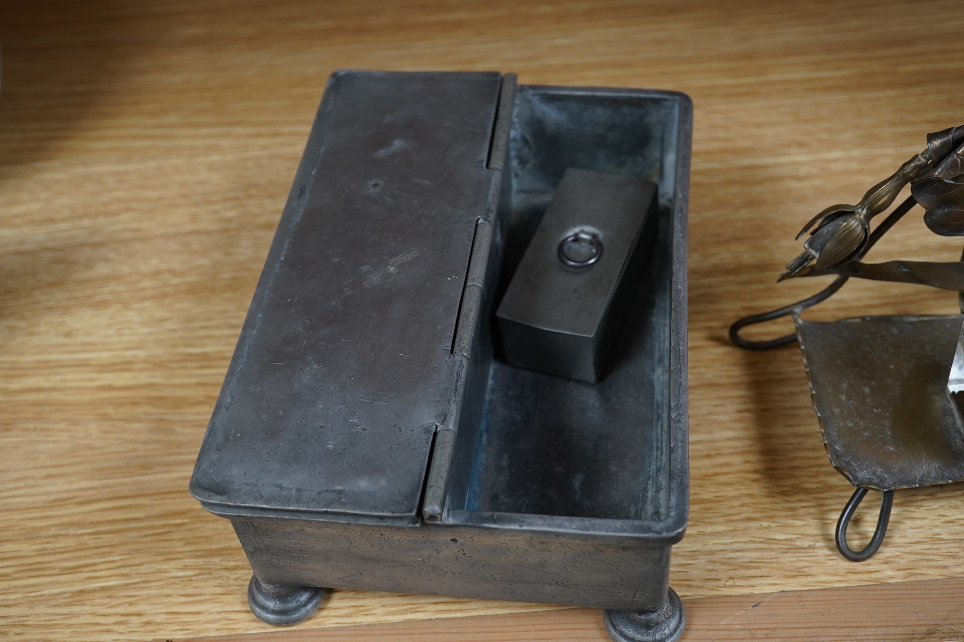 A Georgian pewter standish, 18cm wide, and an inkwell on a brass frame in the form of a fuchsia. Condition - fair